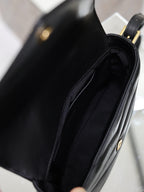 Black YSL bag interior view with side seam and stitched lining