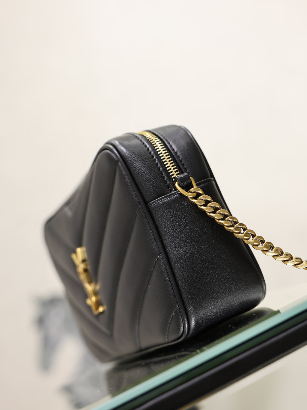 YSL quilted shoulder bag back view, black leather with gold chain and zipper