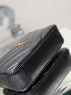 YSL shoulder bag close-up, black leather top edge with gold logo hardware