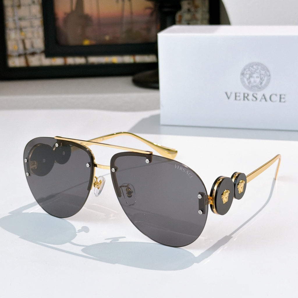 Metal-framed sunglasses with gray tinted lenses and gold-tone temples