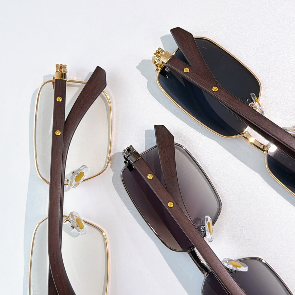 Pairs of eyeglasses: clear and tinted lenses with gold frames and brown temples.
