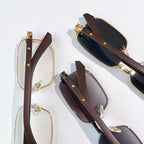 Pairs of eyeglasses: clear and tinted lenses with gold frames and brown temples.