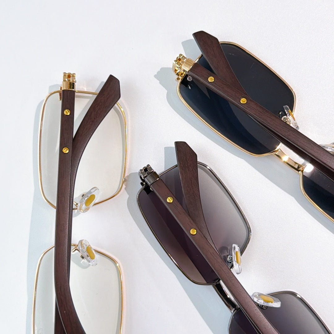 Pairs of eyeglasses: clear and tinted lenses with gold frames and brown temples.