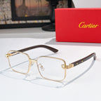 Eyeglasses with clear lenses, gold metal frame, and brown temple arms.