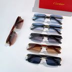 Assorted sunglasses with tinted lenses, black and brown frames, gold hardware