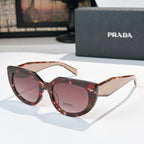 Prada sunglasses with tortoise-pattern frame and pink-tinted lenses, cat-eye