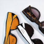 Prada sunglasses set featuring orange-tinted and dark-tinted frames