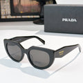 Prada sunglasses with dark frame and gray lenses, cat-eye style
