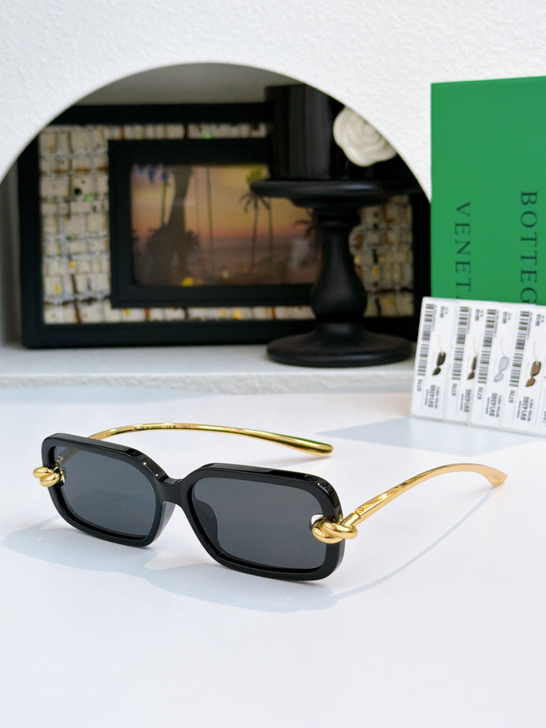 Glasses with dark lenses, black frames, and gold temples