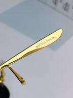Glasses temple detail with gold arm and engraved BOTTEGA VENETA