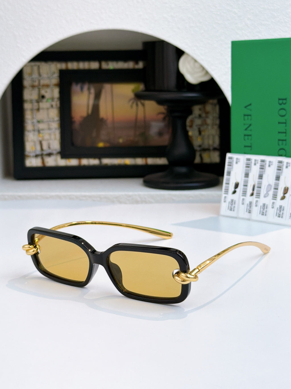 Glasses with yellow lenses, black frames, and gold temples