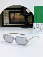 Glasses with light lenses and clear gray frames, silver-toned temples