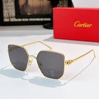 Designer glasses with gold-tone frames and dark gray tinted lenses