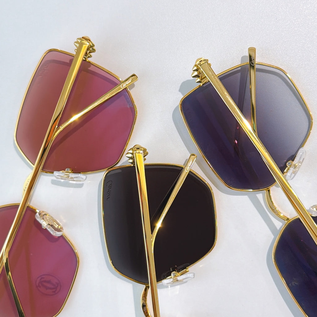 Gold-framed glasses with purple and burgundy tinted lenses, side views