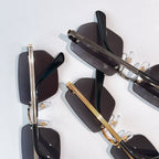 Cartier glasses pair with black and gold frames and dark tinted lenses