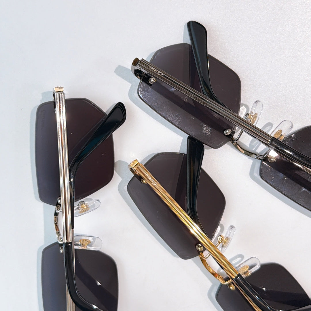 Cartier glasses pair with black and gold frames and dark tinted lenses