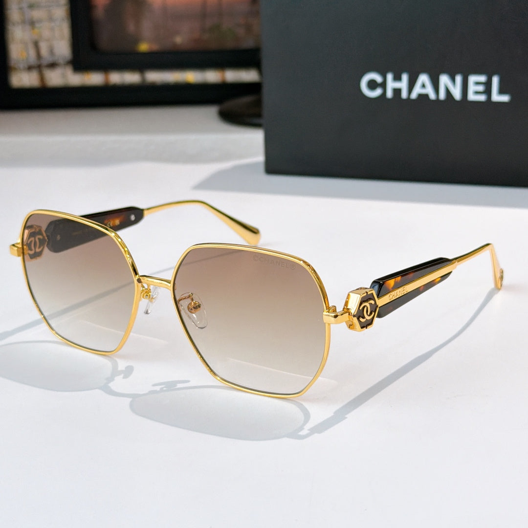 Chanel gold-rim sunglasses with light tinted lenses and patterned dark temples