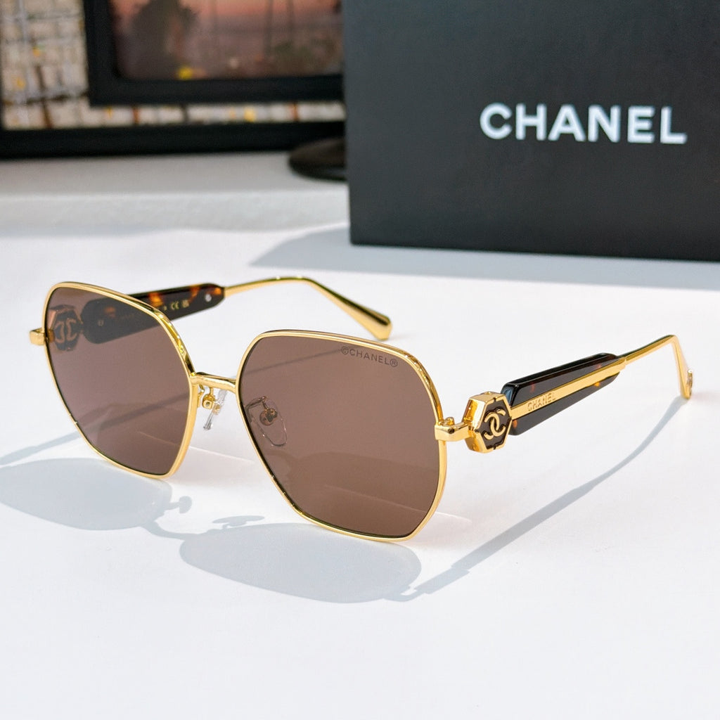 Chanel gold-rim sunglasses with brown tinted lenses and dark patterned temples