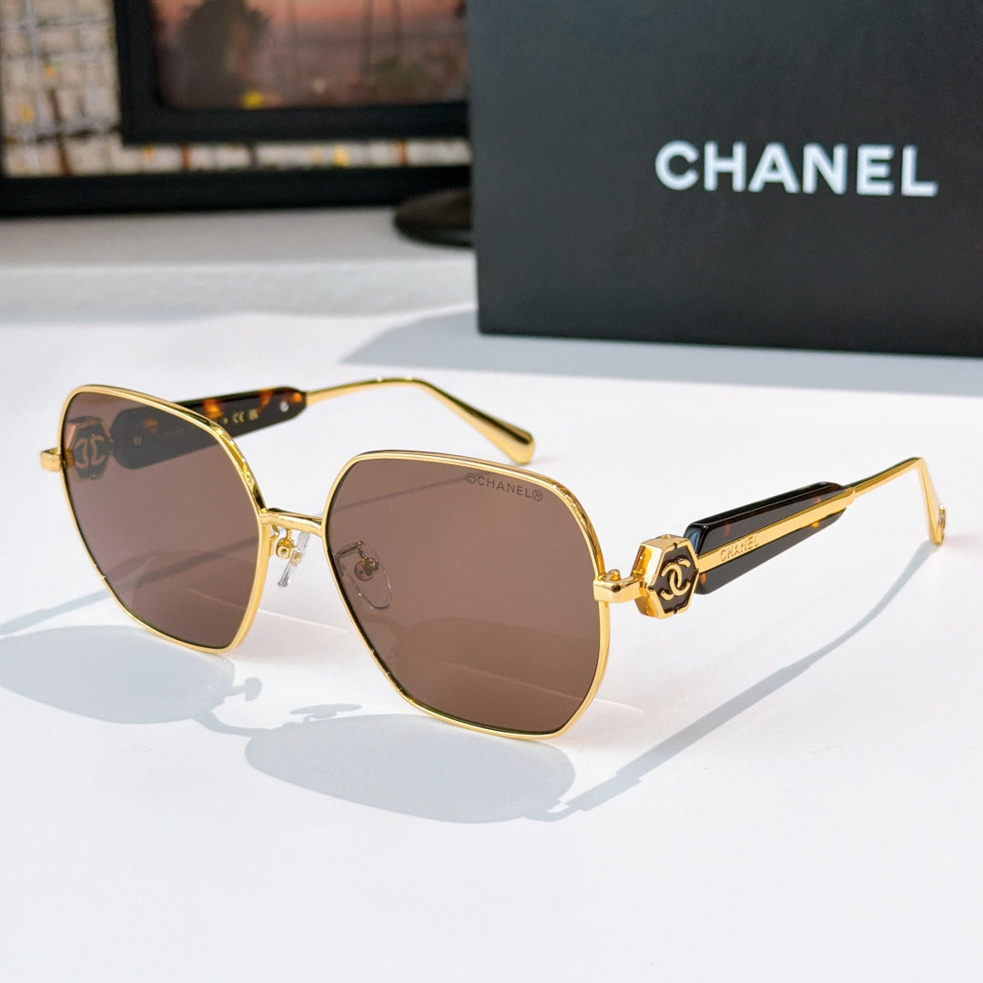 Chanel gold-rim sunglasses with brown tinted lenses and dark patterned temples