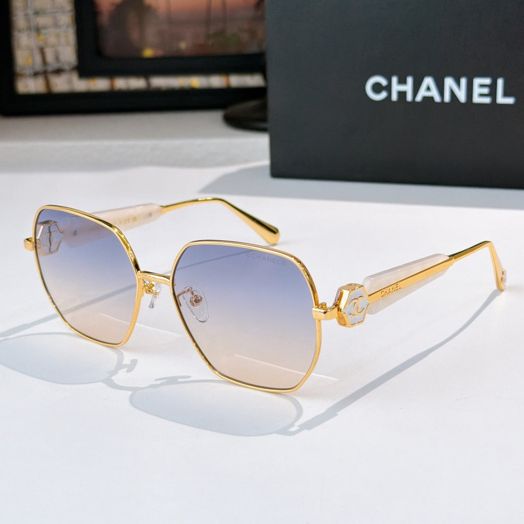 Chanel gold-rim sunglasses with pale blue tinted lenses and light marbled temples