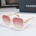 Chanel gold-rim sunglasses with pink tinted lenses and logo hinge detail