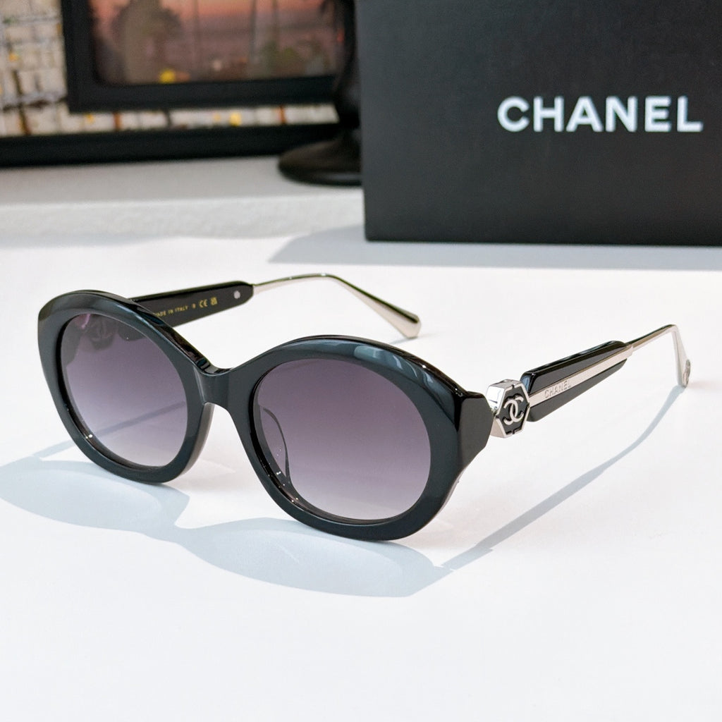 Chanel dark sunglasses with round frames and purple-tinted lenses