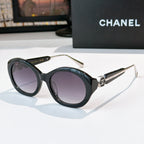 Chanel dark sunglasses with round frames and purple-tinted lenses