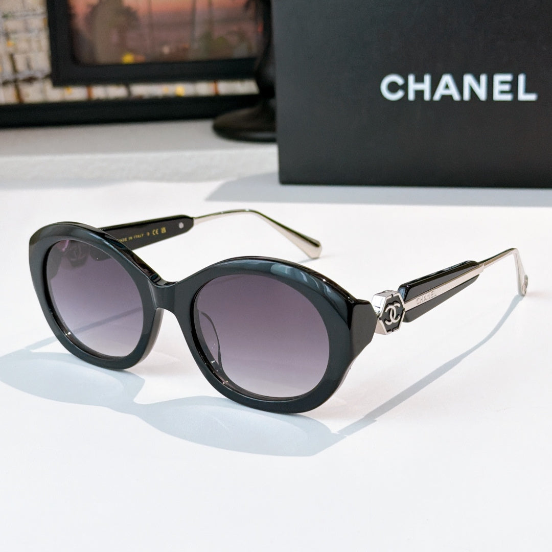 Chanel dark sunglasses with round frames and purple-tinted lenses
