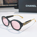 Chanel dark sunglasses with round frames and pink-tinted lenses