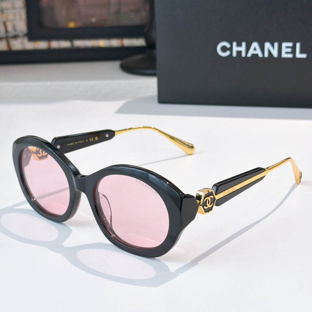 Chanel dark sunglasses with round frames and pink-tinted lenses
