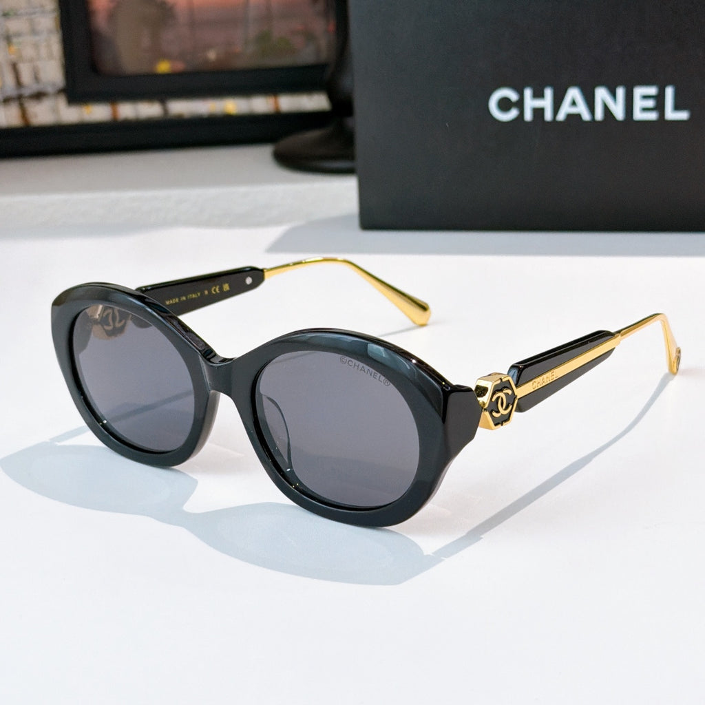 Chanel dark sunglasses with round frames and gray-tinted lenses