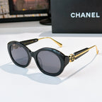 Chanel dark sunglasses with round frames and gray-tinted lenses