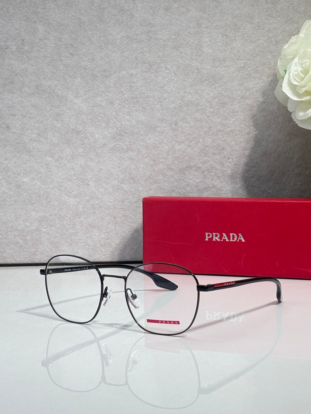 Eyeglasses with dark rectangular frames and clear lenses, front view.