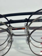 Eyeglasses front view with dark round frames and metal bridge.