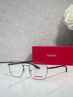 Eyeglasses with dark rectangular frames and clear lenses, angled view.