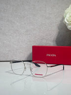 Eyeglasses with dark rectangular frames and clear lenses, side angle.