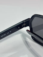 Prada black sunglasses arm with engraved size markings and hinge joint