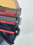 Prada sunglasses temples with red logo bars and black plastic frame tips