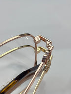 Gucci eyeglasses temple and hinge with gold-tone metal and tortoise-style insert