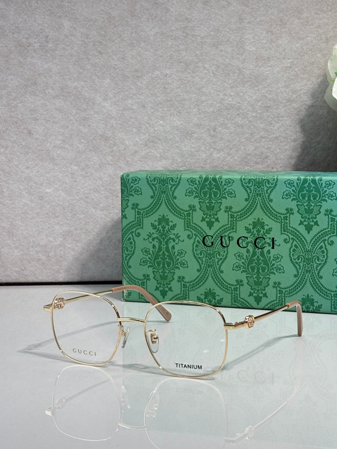Gucci titanium eyeglasses with gold metal frame and clear lenses, thin rim design