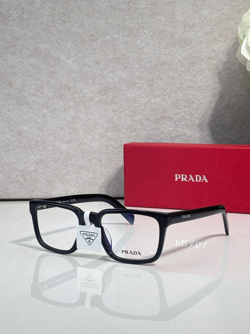 Prada black rectangular eyeglasses with white bridge detail and clear lenses