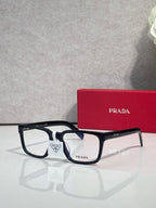 Prada black rectangular eyeglasses with white bridge detail and clear lenses