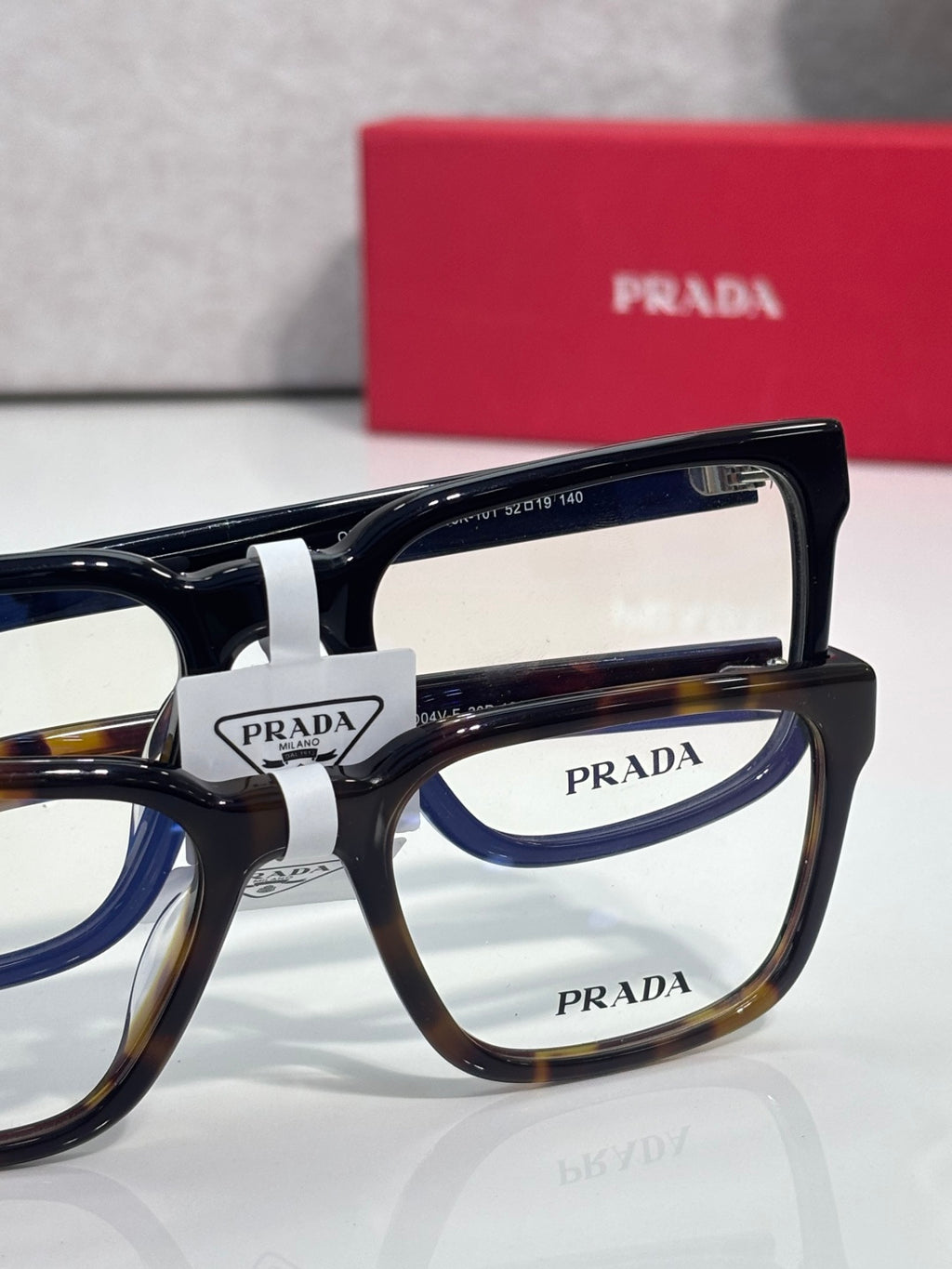 Prada eyeglasses set with clear lenses and black-and-tortoise frames