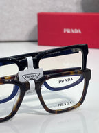 Prada eyeglasses set with clear lenses and black-and-tortoise frames
