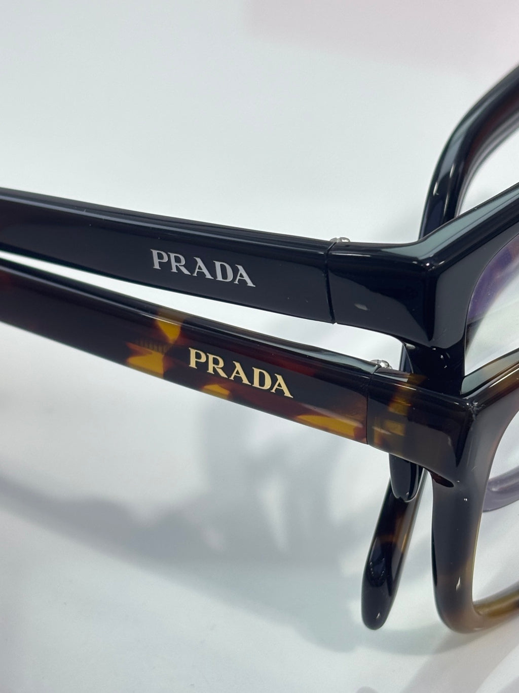Prada black and tortoise eyeglass frame with PRADA logo bar detail
