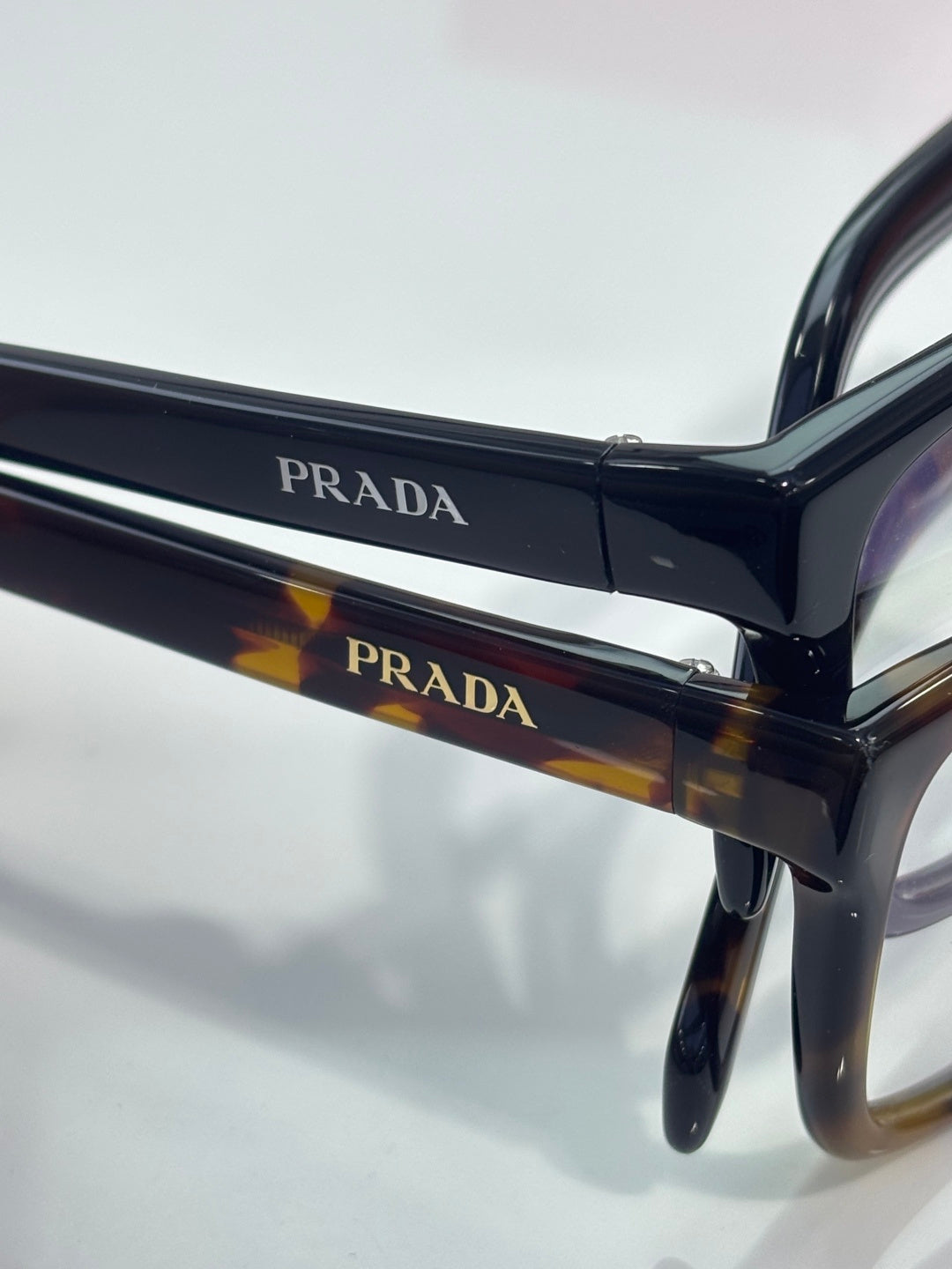 Prada black and tortoise eyeglass frame with PRADA logo bar detail