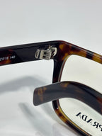 Prada acetate eyeglasses with dark and amber tortoise temple and clear lens