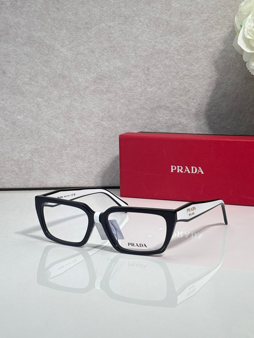 Prada eyeglasses with black frame and dark blue temples, frontal view