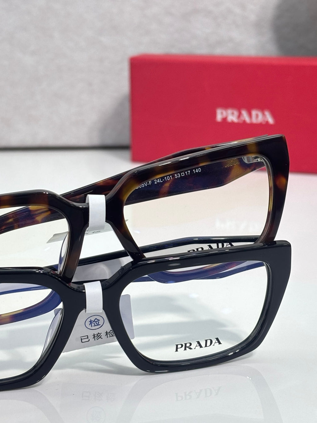 Prada eyeglasses with tortoiseshell upper frame and black lower frame
