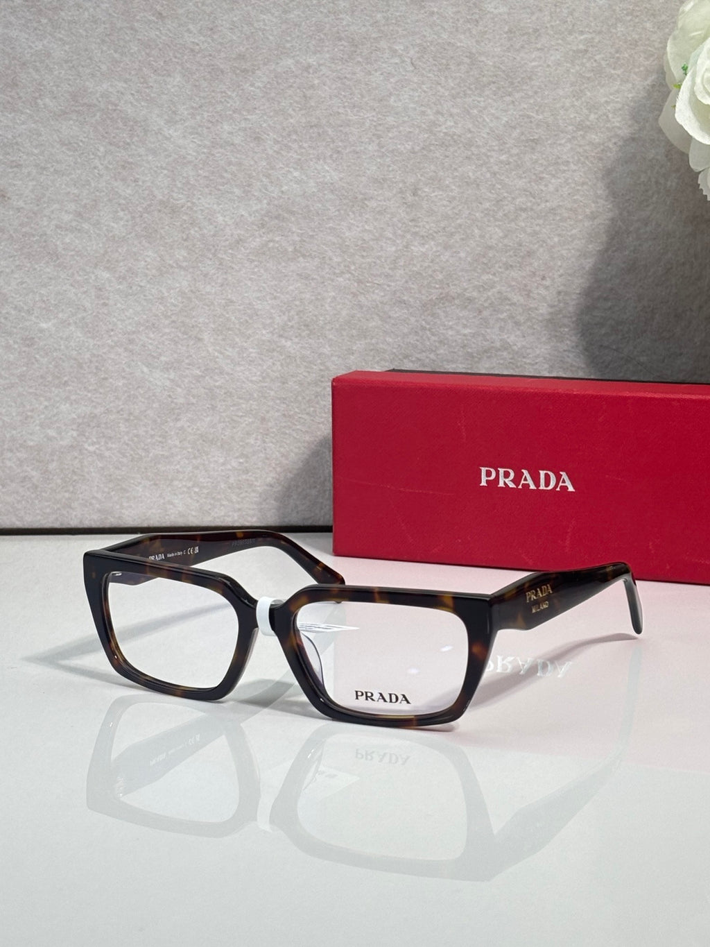 Prada eyeglasses with black and dark blue frame, rectangular clear lenses